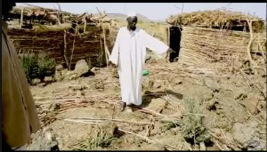 Father Yacoub Omar (L)  & Mayor Ayman Omar (R) at bomb site (Nuba Reports)